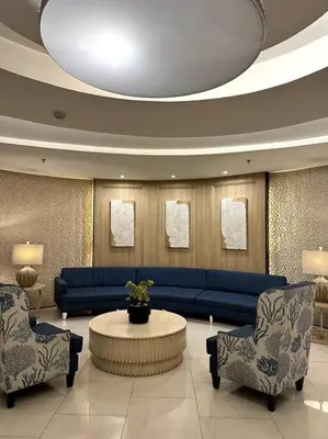 a living room with a blue couch and two chairs at Shell res nr MOA 2BR free parking in Manila