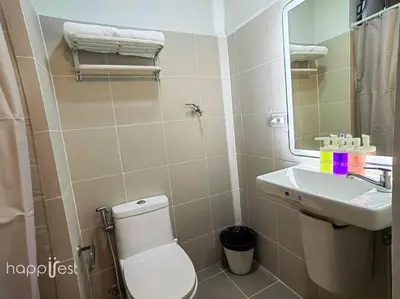a bathroom with a toilet and a sink and a mirror at Happirest at Coast Residences, Pasay - 1 Bedroom with Balcony in Manila