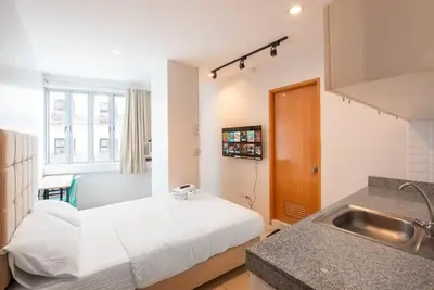 a small room with a bed and a sink at JP Santiago Studio Makati J207 in Manila