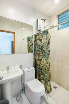 a bathroom with a white toilet and a sink at JP Santiago Studio Makati J207 in Manila