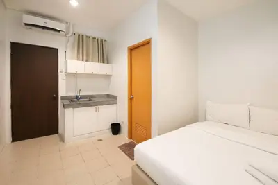 a small bedroom with a bed and a sink at JP Santiago Studio Makati J303 in Manila