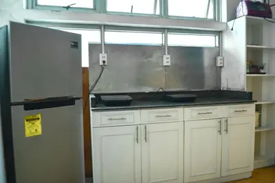 a kitchen with white cabinets and a refrigerator at JP Santiago Studio Makati J303 in Manila