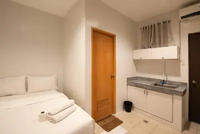 a small room with a bed and a sink at JP Santiago Studio Makati J304 in Manila
