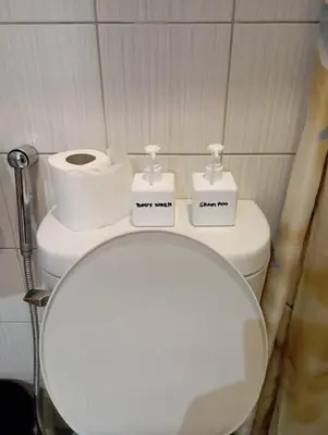 a bathroom with a toilet and two rolls of toilet paper at JP Santiago Studio Makati J307 in Manila