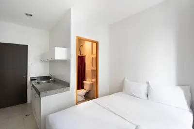 a white bedroom with a white bed and a sink at JP Santiago Studio Makati J308 in Manila