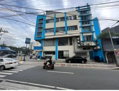 a person riding a scooter in front of a building at JP Santiago Studio Makati J308 in Manila