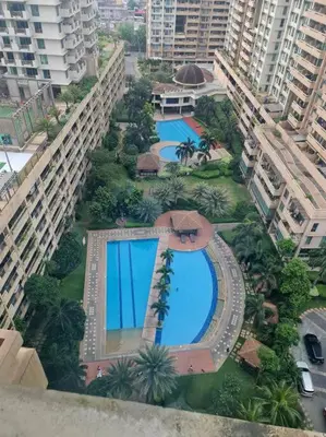 an overhead view of two swimming pools in a city at Tivoli Garden Residences - Iris Tower in Manila