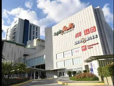 a building with a sign on the side of it at Tivoli Garden Residences - Iris Tower in Manila