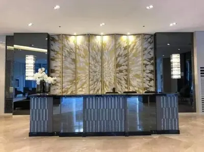 a lobby with a reception desk in a building at Chic 2 Bedroom EDSA APT with Balcony in Manila