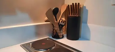 a counter top with a container of kitchen utensils at AIR Luxury Makati CBD with balcony in Manila