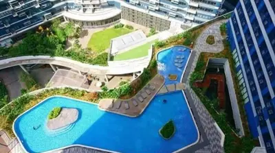an aerial view of a building with a swimming pool at AIR Luxury Makati CBD with balcony in Manila