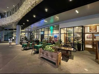 a shopping mall with tables and chairs and a building at AIR Luxury Makati CBD with balcony in Manila