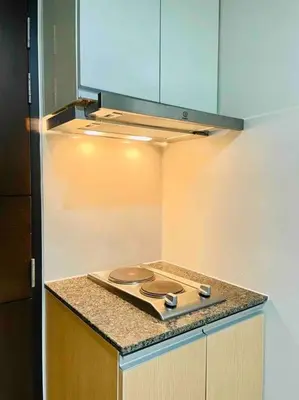 a kitchen with a stove top in a kitchen at One Uptown 2-bed 1BR w/XBOX, Netflix in BGC in Manila