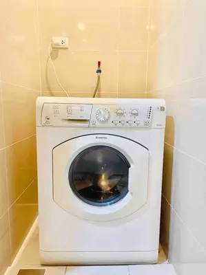 a white washing machine sitting in a bathroom at One Uptown 2-bed 1BR w/XBOX, Netflix in BGC in Manila
