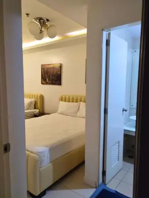 a bedroom with a bed and a ceiling fan at 40 Percent Promo Off This Month, Balcony Ocean View Plus Free Pool & Sauna Access Exclusive 2025 Rates at Walking Distance US Embassy, Front of Robinsons Place MANILA, Bellagio and Experience Breathtaking Manila Bay Views in Manila