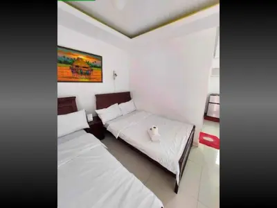 a bedroom with two beds and a painting on the wall at Family Room Staycation In The Heart Of Manila, with 2 Balcony Plus 40 Percent Promo Discount Plus Free Pool Access, Plus Free Sauna Promo in Manila Bay, Robinsons Place, Ermita, Pgh, Bellagio, UP Pedrogil, Staycation Updated 2025 Price in Manila