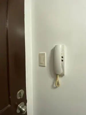 a phone is hanging on the side of a door at Family Room Staycation In The Heart Of Manila, with 2 Balcony Plus 40 Percent Promo Discount Plus Free Pool Access, Plus Free Sauna Promo in Manila Bay, Robinsons Place, Ermita, Pgh, Bellagio, UP Pedrogil, Staycation Updated 2025 Price in Manila