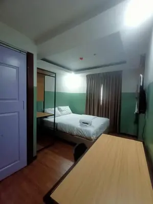 a room with a bed and a table in it at St. Marvin Studio Makati M309 in Manila