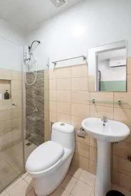 a bathroom with a toilet and a sink and a shower at St. Marvin Studio Makati M308 in Manila