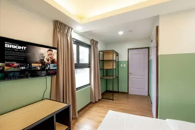a room with a bed and a poster on the wall at St. Marvin Studio Makati M306 in Manila
