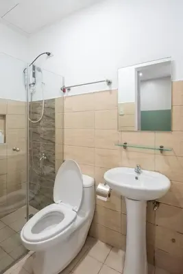 a bathroom with a toilet and a sink at St. Marvin Studio Makati M304 in Manila