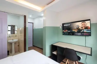a bedroom with a desk and a tv on the wall at St. Marvin Studio Makati M303 in Manila