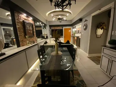 a dining room with a glass table and chairs at Awesome Eastwood Condo Suite! in Manila
