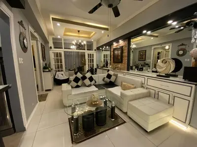 a living room with a couch and a table at Awesome Eastwood Condo Suite! in Manila