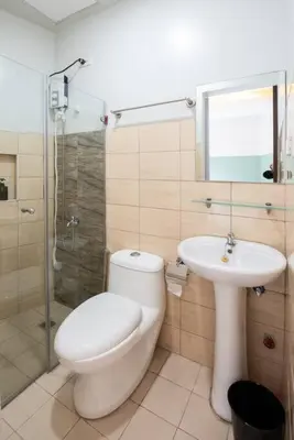 a bathroom with a toilet and a sink and a shower at St. Marvin Studio Makati M302 in Manila