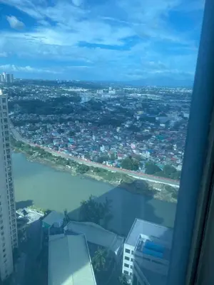 a view of a city and a river from an airplane at Elegant 2BR, 2 BA Suite Beside Eastwood Mall in Manila