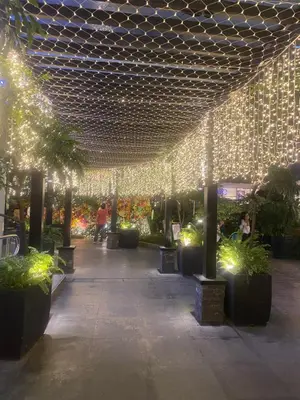 a walkway with lights and plants in a building at Elegant 2BR, 2 BA Suite Beside Eastwood Mall in Manila