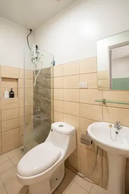 a bathroom with a shower and a toilet and a sink at St. Marvin Studio Makati M204 in Manila
