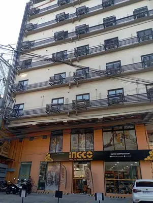 a large building with a store on the side of it at St. Marvin Studio Makati M203 in Manila