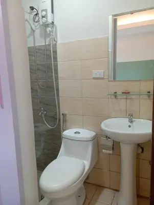 a bathroom with a toilet and a shower and a sink at St. Marvin Studio Makati M202 in Manila