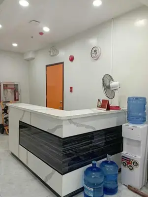 a kitchen with a counter with blue water bottles at St. Marvin Studio Makati M202 in Manila