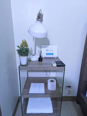 a desk with a lamp and a computer on it at Palmtree Two Villas Across Terminal 3 or Manila Airport in Manila