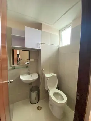 a small bathroom with a toilet and a sink at Anuva Residence Condominium in Manila
