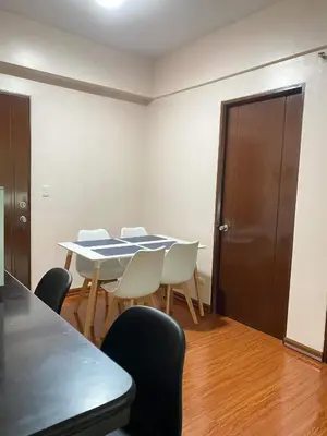 a dining room with a table and chairs at Anuva Residence Condominium in Manila