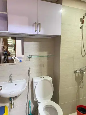 a bathroom with a toilet and a sink at Anuva Residence Condominium in Manila
