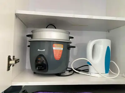 a large pot sitting on a shelf next to a toaster at Anuva Residence Condominium in Manila
