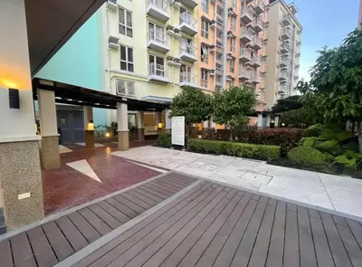 an empty courtyard in a building with tall buildings at Neat Unit in Holland Park Southwoods in Biñan