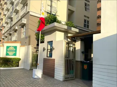 a building with a red flag on top of it at Neat Unit in Holland Park Southwoods in Biñan