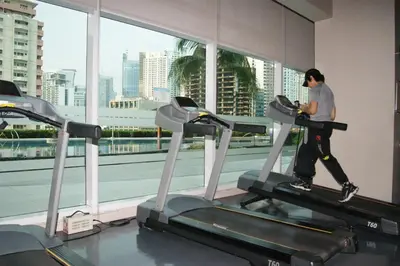 a man running on a treadmill in a gym at The Beacon Makati by mvmtransient in Manila