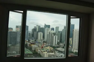 a view of a city skyline from a window at The Beacon Makati by mvmtransient in Manila