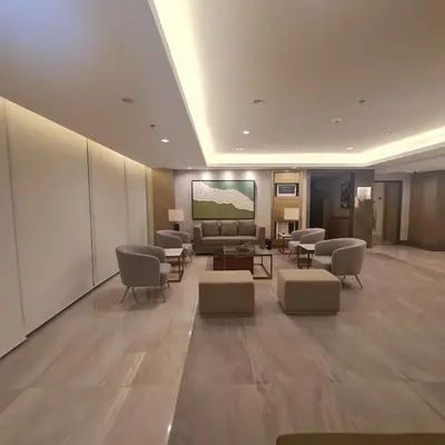 a lobby with a waiting room with a couch and chairs at Homely Green 2 Residences T2 in Dasmariñas