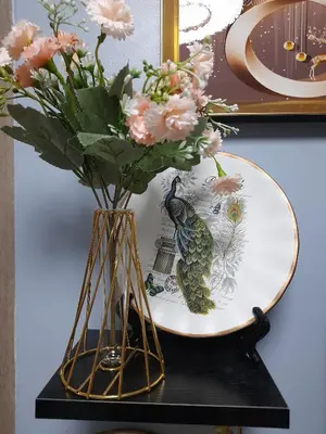 a vase with flowers on a table next to a plate at FourSphere staycation in Manila