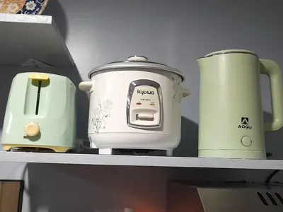 a shelf with two toasters and a toaster on it at FourSphere staycation in Manila