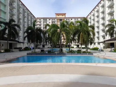 a swimming pool in front of a large building at FourSphere staycation in Manila