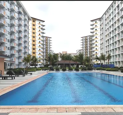 a large swimming pool in front of some buildings at FourSphere staycation in Manila