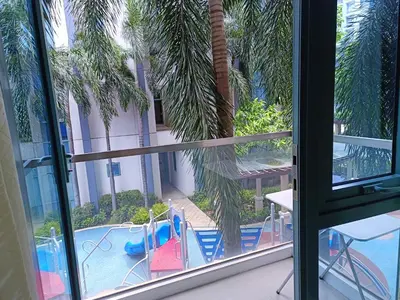 a view of a pool from a window at 1BR at TWO PALMTREE VILLAS Across Manila airport terminal 3 in Manila